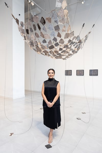 Shaima Shamsi with her installation, Notes on Being Swallowed by a Cavity, for the Mutable Devotions exhibition. Photo: NYUAD