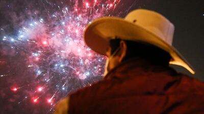 A supporter of leftist school teacher Pedro Castillo watches fireworks during celebrations in downtown Lima following the official proclamation of him as Peru’s president-elect.