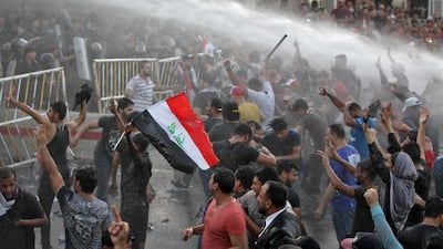 Iraqi protesters chant slogans and wave national flags in the capital Baghdad's Tahrir Square. AFP