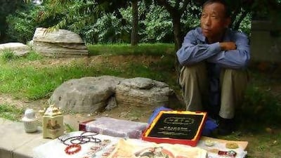Li Zhongtang, a migrant worker, sells Mao Zedong souvenirs in Bejing. He would like China to return to policies that distributed wealth equitably.