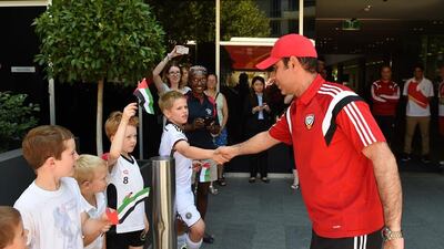 UAE football coach Mahdi Ali greets fans as the team arrive at their hotel in Canberra, Australia on Wednesday ahead of the 2015 Asian Cup.