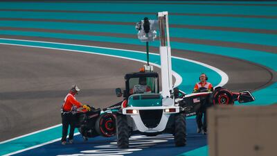 Nico Hulkenberg's Haas is towed away after he damaged the rear while spinning out on turn one. Victor Besa / The National