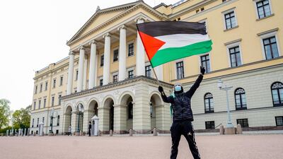 A lone protester waves the Palestine flag during a demonstration in support of Palestine, outside the Israeli embassy, in Oslo, Norway. EPA