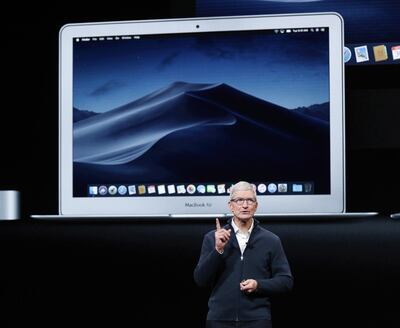 Apple CEO Tim Cook speaks with a MacBook Air behind him during an Apple special event. EPA