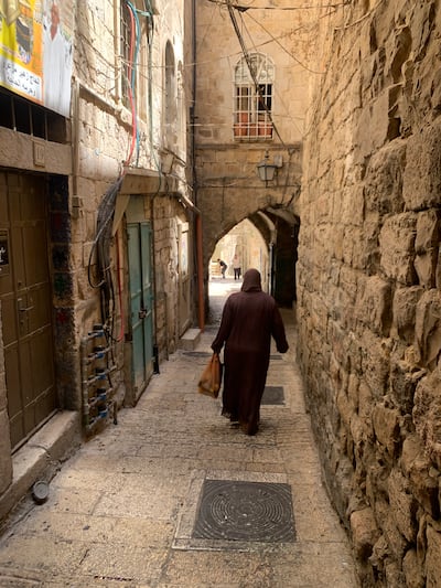 A Palestinian woman walks through Jerusalem’s Old City. Hamza Hendawi / The National