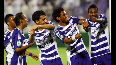 The Al Ain team celebrates with Asomah Gyan, right, after he scored a hat-trick goals against Dubai in Al Ain. (Satish Kumar / The National)