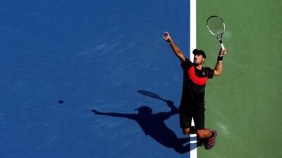 Feliciano Lopez of Spain serves against Ivan Dodig of Croatia during their men's singles first-round match in the US Open at the USTA Billie Jean King National Tennis Center on August 27, 2014, in the Flushing neighborhood of the Queens borough of New York City. Elsa / AFP