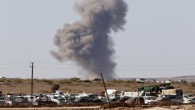 Smoke rises from the Syrian town of Kobani after an air raid, seen from near the Mursitpinar border crossing on the Turkish-Syrian border. Unit Bektas / Reuters