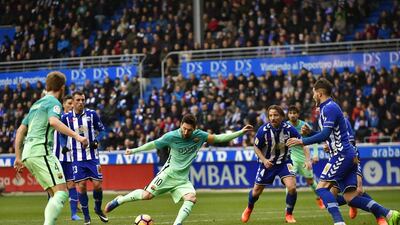 Barcelona’s Lionel Messi, centre, prepares to kick the ball during the match against Alaves at Mendizorroza Stadium, in Vitoria, northern Spain. Alvaro Barrientos / AP Photo