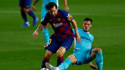 Barcelona's Lionel Messi, left, is challenged by Leganes' Ruben Perez. AP Photo
