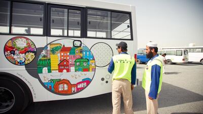 Labourers look on to their buses, that have been painted as part of the Restart The Art programme. (Courtesy: The Sameness Project)