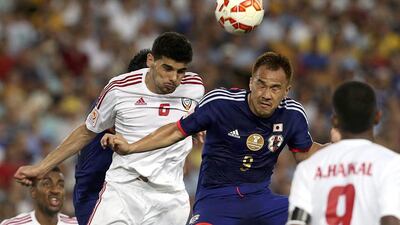 Mohaned Salem, left, fights for the ball against Japan's Shinji Okazaki during their Asian Cup quarter-final at Stadium Australia in Sydney on January 23, 2015. Steve Christo / Reuters