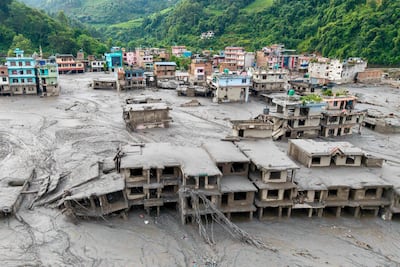 Houses deluged by sludge after flash floods in Devighat, Bidur Municipality, in Nepal's Nuwakot district on August 27. AFP