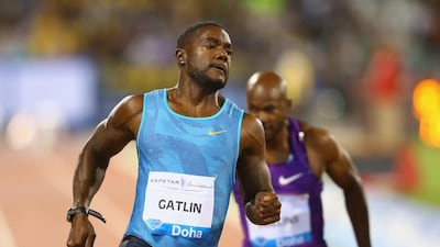 Justin Gatlin of the United States crosses the line to win the Men's 100m with Kim Collins of St Kitts and Nevis (R) finishing fourth during the Doha IAAF Diamond League 2015 meeting at the Qatar Sports Club on May 15, 2015 in Doha, Qatar. Francois Nel / Getty Images