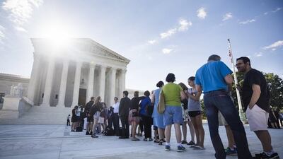 People gathered outside the US supreme court in Washington as the justices prepared to deliver a ruling on president Donald Trump’s travel ban on visitors to the US from six predominantly Muslim countries on June 26, 2017. Jim Lo Scalzo / EPA
