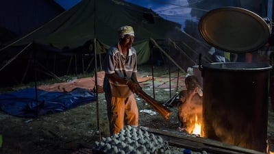 A Rohingya migrant helps volunteer cooking at a temporary shelter on May 17 in Kuala Langsa, Aceh province, Indonesia. Ulet Ifansasti/Getty Images