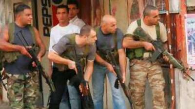 Fatah gunmen take positions inside the Ain el-Helweh Palestinian refugee camp in Beirut.