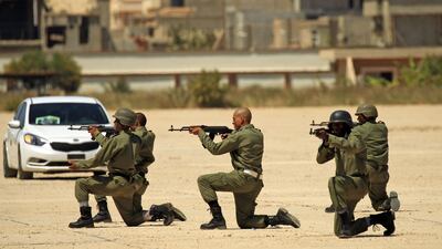 Fighters from the Libyan National Army attend their graduation ceremony at a military academy in Libya's eastern city of Benghazi on April 18, 2019. AFP