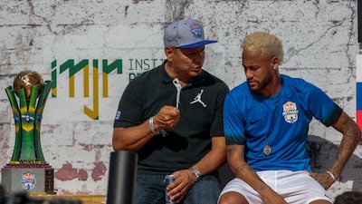 Neymar, right, listens to his father Neymar Sr during a five-a-side football tournament in Sao Paulo. Miguel Schincariol / AFP