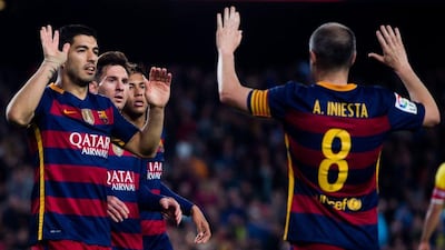 Luis Suarez, left, thanks Andres Iniesta after the Barcelona set up one of his four goals in the 6-0 thrashing of Sporting Gijon. Denis Doyle/Getty Images