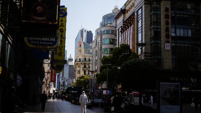 A security guard in personal protective equipment (PPE) walks at a main shopping area following the coronavirus disease (COVID-19) outbreak in Shanghai. Reuters