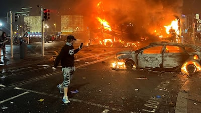 A car and bus burn at the junction of Bachelors Walk and the O'Connell Bridge in Dublin. AFP