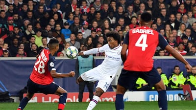 Willian shoots and scores his team's second goal. AFP