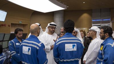 Sheikh Mohammed bin Zayed, centre, Crown Prince of Abu Dhabi and Deputy Supreme Commander of the UAE Armed Forces, speaks with Al Hosn gas employees. Ryan Carter / Crown Prince Court - Abu Dhabi