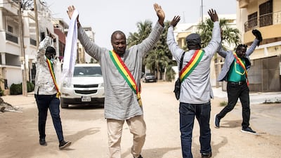 Senegalese opposition officials hold their hands up after tear gas was fired while they were trying to meet their leader, Ousmane Sonko, who is under house arrest in Dakar. AFP