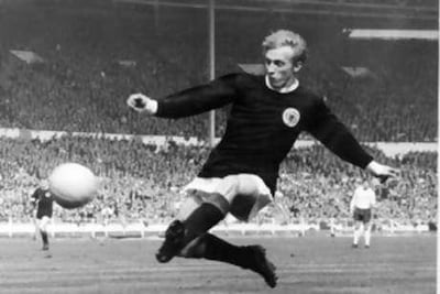 Denis Law, pictured here taking a shot against England at Wembley in 1967, won 55 Scotland caps between 1959-1974.