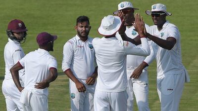West Indies players celebrate a wicket against Pakistan on Sunday during Day 1 of the third Test in Sharjah. Aamir Qureshi / AFP / October 30, 2016