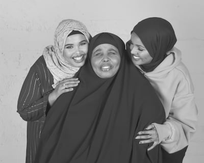Halima Aden, far right, with her mother and sister. Courtesy Halima Aden