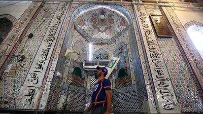 A rescue worker inspects the scene of an explosion at an Islamic seminary in Peshawar, Pakistan. EPA