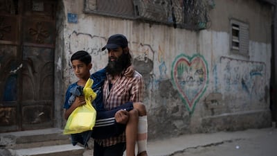 Raed Abu Khader, right, carries his 12-year-old son Mohammed as they return from the hospital in Gaza City. Mohammed was shot in the leg at one of the demonstrations on Gaza strip's border with Israel. Ever since Hamas launched demonstrations in March against Israel's blockade of Gaza, children have been a constant presence in the crowds. Since then, U.N. figures show that 948 children under 18 have been shot by Israeli forces and 2,295 have been hospitalized, including 17 who have had a limb amputated. AP