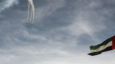 The Al Fursan aerobatic team light up the skyline of Abu Dhabi. Khushnum Bhandari / The National