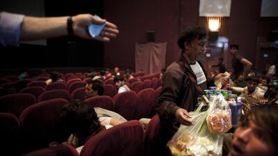 Members of the audience at Ariana Cinema purchase concessions during the intermission in an Indian movie.