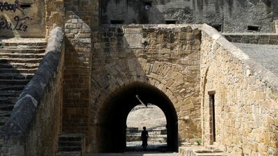 A woman walks by Paphos Gate near the United Nations Buffer Zone in Nicosia, Cyprus. Reuters