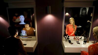 A woman looks at a mirror next to the wax figure of Paris Hilton at Grevin Wax Museum in Seoul, South Korea, July 30, 2015. The French-based Musee Grevin has opened its first Asian outpost in central Seoul with about 80 wax figures, including Korean cultural and sports figures. Kim Hong-Ji / Retuers