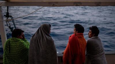 Migrants look at the sea from the deck of the boat of the NGO Proactiva Open Arms. AFP