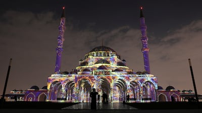 People view the illuminated Sharjah Masjid. EPA