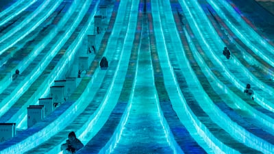 In this photo released by Xinhua News Agency, tourists enjoy on an ice slide at the Harbin Ice-Snow World in Harbin in northeastern China's Heilongjiang Province on Jan. 2, 2024. (Xie Jianfei / Xinhua via AP)