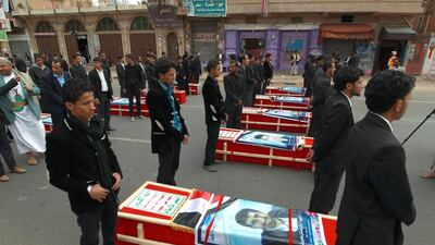 Supporters of the Yemeni Shiite Houthi movement assemble around the coffins of members killed in a suicide bombing on October 9 during a funeral procession on Tuesday in the capital Sanaa. Mohammed Huwais / AFP