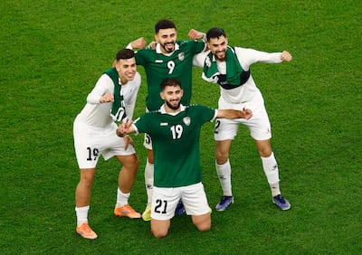 Palestinian players celebrate after a draw with Syria took them through to the quarter-finals as group winners. Reuters