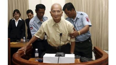 The most senior surviving leader of the Khmer Rouge, 'Brother Number Two' Nuon Chea (centre), is helped up by police officers at the Extraordinary Chambers in the Court of Cambodia. Chor Sokunthea Reuters