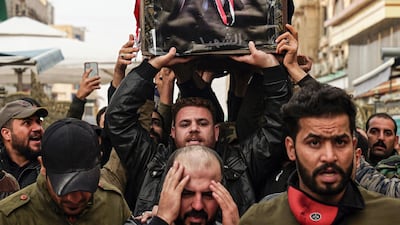 Iraqi mourners carry the coffin of a protester and citizen journalist, who was killed during a demonstrations the previous day in Baghdad, during his funerary procession in the central holy Shia city of Najaf on December 7, 2019 AFP