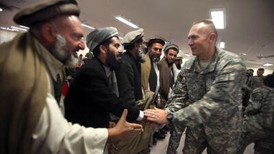 A US Army officer greets Shinwari tribal leaders during a meeting in Nangarhar province on January 27, 2010.