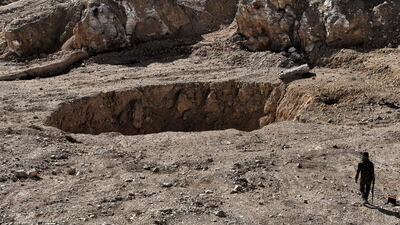 A sinkhole in the village of Athbah, south of Mosul which witnesses say hold bodies of those executed by ISIL. No exact figures exist for the number of bodies that could be buried in the sinkhole but Human Rights Watch estimates that 4,000 people could be in it. Aris Messinis/AFP
