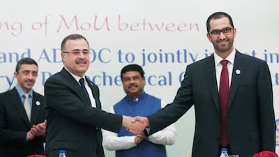 Saudi Aramco chief executive Amin Nasser shakes hands with Adnoc chief executive Ahmed al Jaber, also a minister of state of the UAE government, as India's Oil Minister Dharmendra Pradhan and UAE's Foreign Minister Sheikh Abdullah bin Zayed Al Nahyan watch, during an event in New Delhi, India on June 25, 2018. Adnan Abidi / Reuters