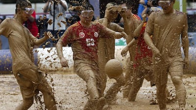 Players from two opposing teams compete in a mud field during the Swamp Soccer 2016 friendly matches at a sports complex in Beijing, China. A total of 32 teams are participating in the Swamp Soccer China tournament, which is played for 24 minutes on a mud field with a six-a-side format. Rolex Dela Pena / EPA