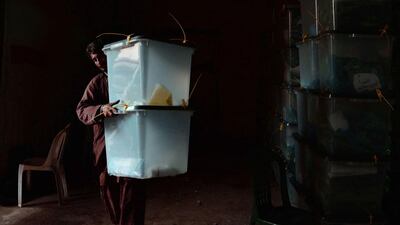 An Afghan election commission worker carries a ballot box at a vote counting centre in Jalalabad on April 6. A roadside bomb hit a truck carrying full ballot boxes in northern Afghanistan, killing three people a day after the country voted for a successor to President Hamid Karzai. Eight boxes of votes were destroyed in the blast, which came as the three leading candidates voiced concerns about possible fraud. Noorullah Shirzada / AFP Photo